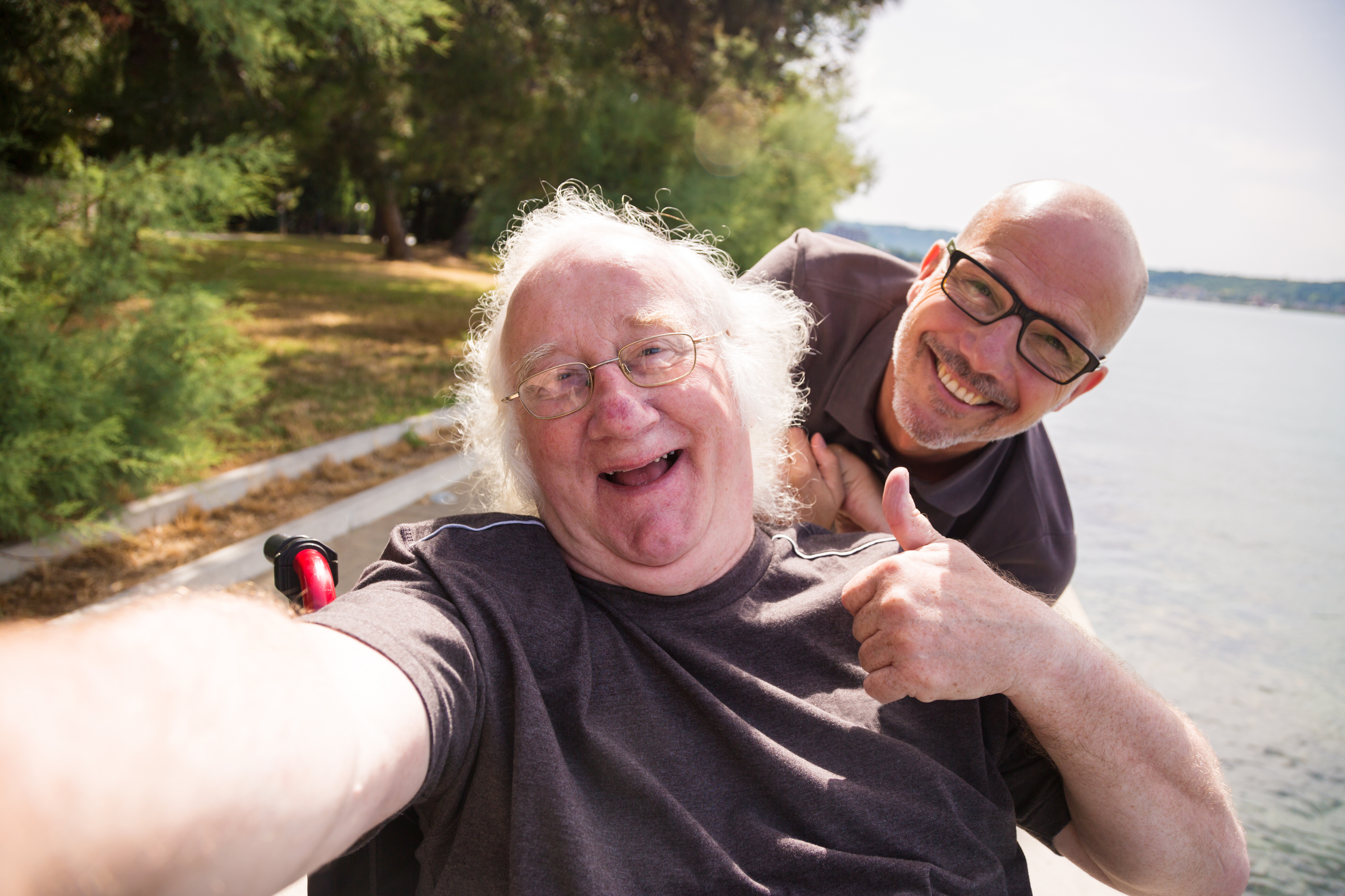 Source: iStock - Selfie taken by man using a wheelchair with a friend